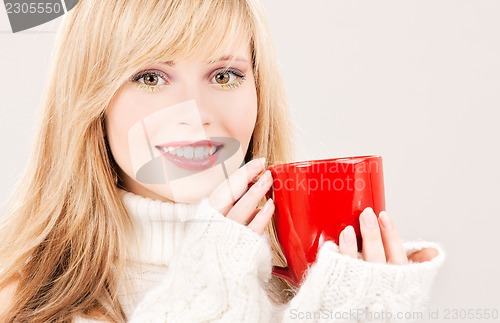 Image of happy teenage girl with red mug