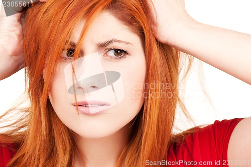 Image of unhappy redhead woman