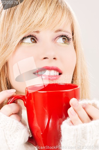 Image of happy teenage girl with red mug