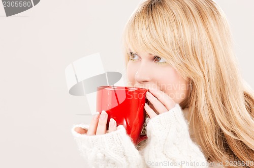 Image of happy teenage girl with red mug