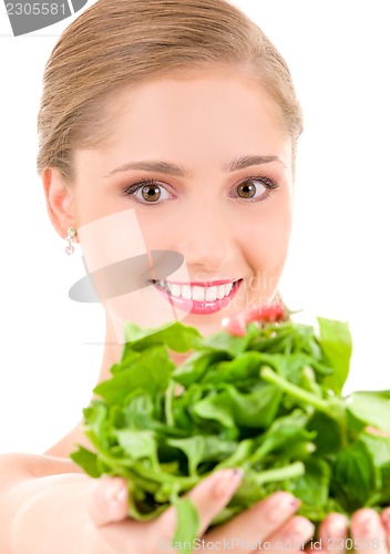 Image of happy woman with spinach
