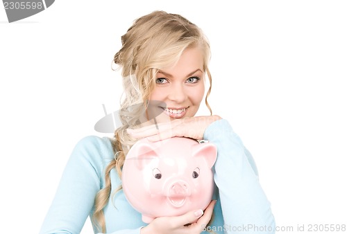 Image of lovely woman with piggy bank