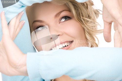 Image of lovely blonde creating a frame with hands