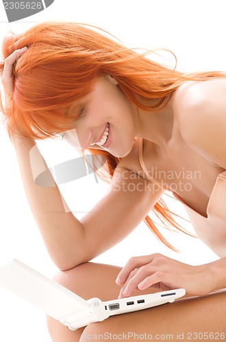 Image of happy redhead woman with laptop computer