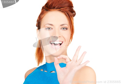 Image of lovely redhead showing ok sign