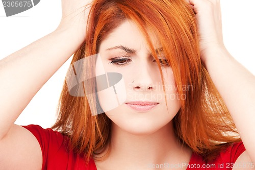 Image of unhappy redhead woman