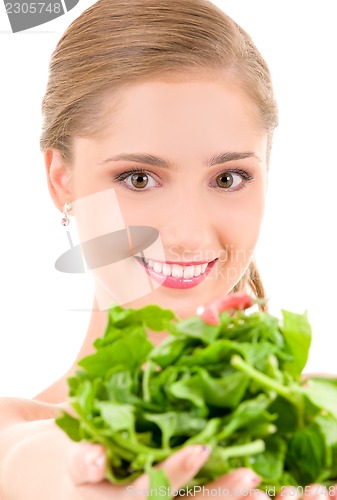 Image of happy woman with spinach