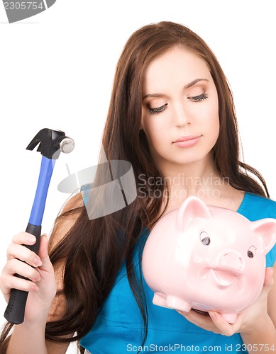 Image of teenage girl with piggy bank and hammer