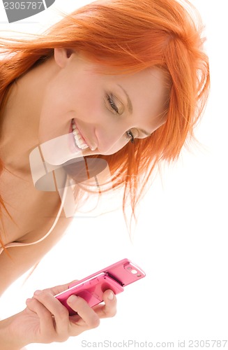 Image of happy redhead woman with cell phone