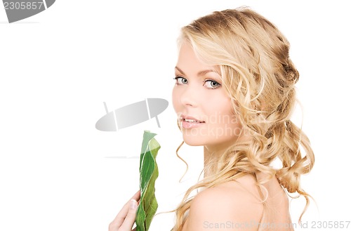 Image of woman with green leaf
