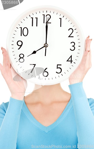 Image of woman with big clock covering face