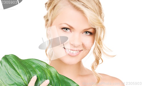 Image of woman with green leaf