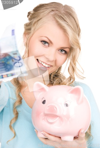 Image of lovely woman with piggy bank and money