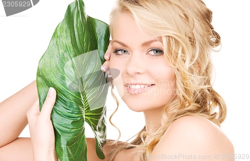 Image of woman with green leaf