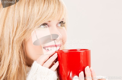 Image of happy teenage girl with red mug