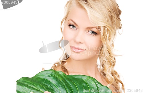 Image of woman with green leaf