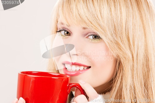 Image of happy teenage girl with red mug