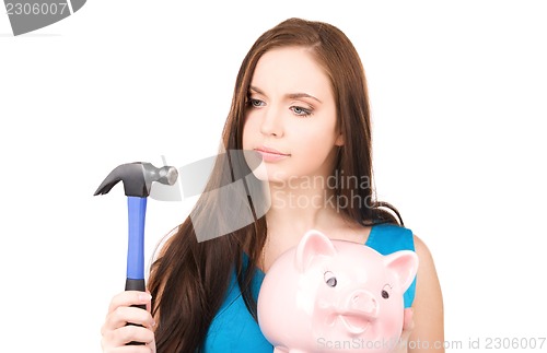 Image of teenage girl with piggy bank and hammer