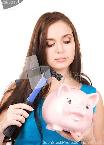 Image of teenage girl with piggy bank and hammer