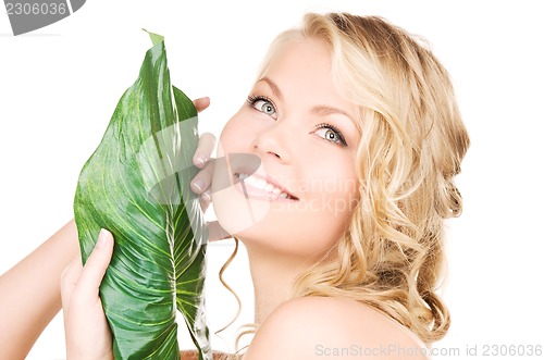 Image of woman with green leaf