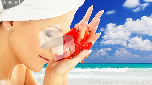 Image of woman with flower petals over resort background