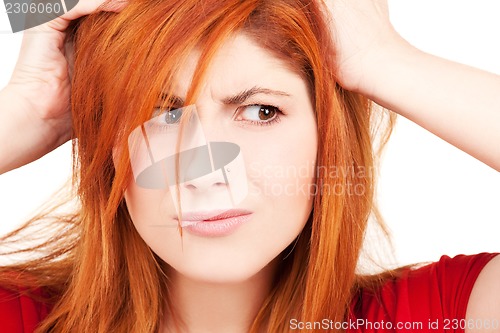 Image of unhappy redhead woman