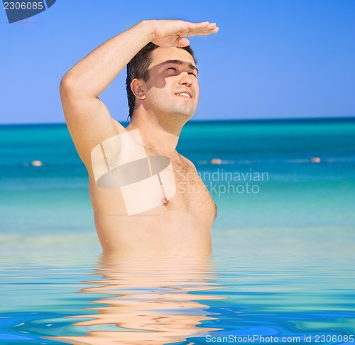 Image of happy tanned man on the beach