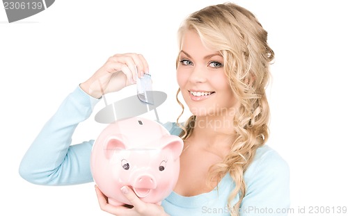 Image of lovely woman with piggy bank and money