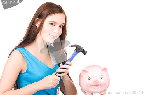 Image of teenage girl with piggy bank and hammer