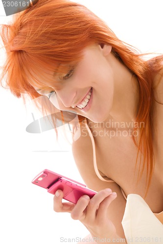 Image of happy redhead woman with cell phone