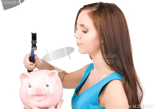 Image of teenage girl with piggy bank and hammer