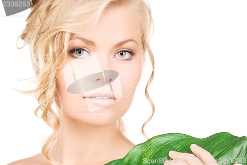 Image of woman with green leaf