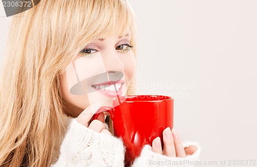 Image of happy teenage girl with red mug