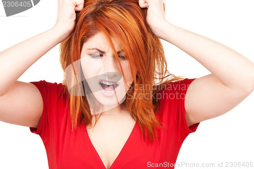 Image of unhappy redhead woman