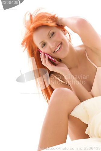 Image of happy redhead woman with cell phone
