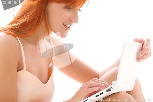 Image of happy redhead woman with laptop computer