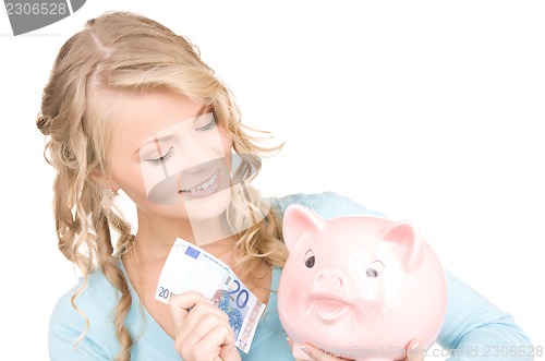 Image of lovely woman with piggy bank and money