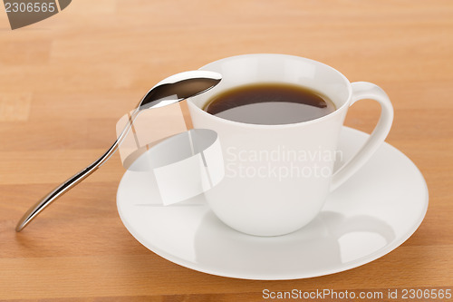 Image of Cup of coffee and silver spoon