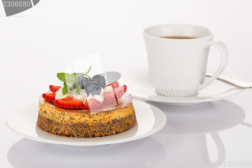 Image of Cheesecake, cup of coffee and spoon