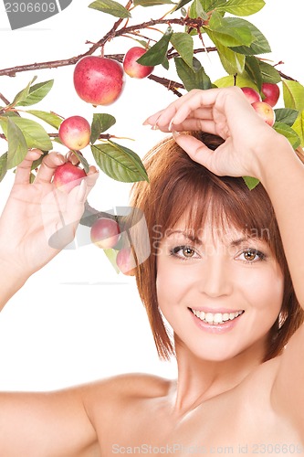 Image of happy woman with apple twig