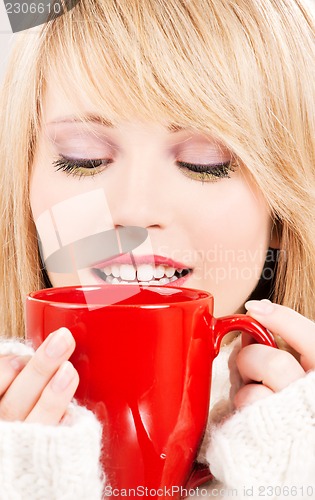 Image of happy teenage girl with red mug