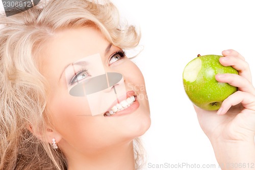 Image of young beautiful woman with green apple