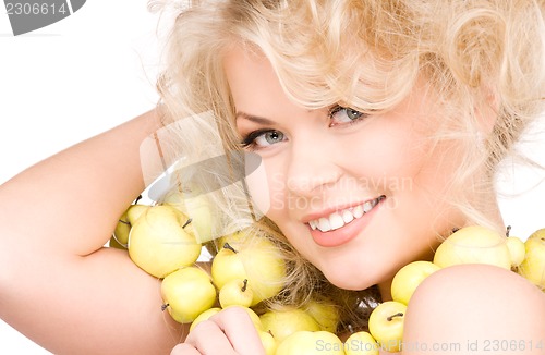 Image of happy woman with green apples