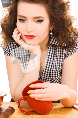 Image of young attractive woman in the kitchen