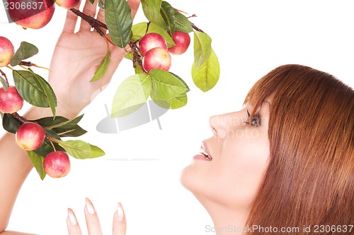 Image of happy woman with apple twig