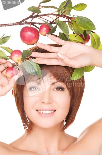 Image of happy woman with apple twig
