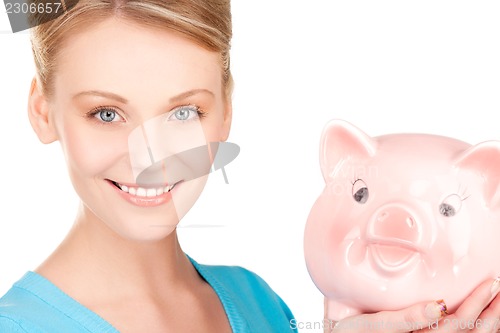 Image of lovely woman with piggy bank