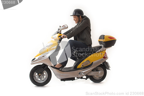 Image of woman riding scooter