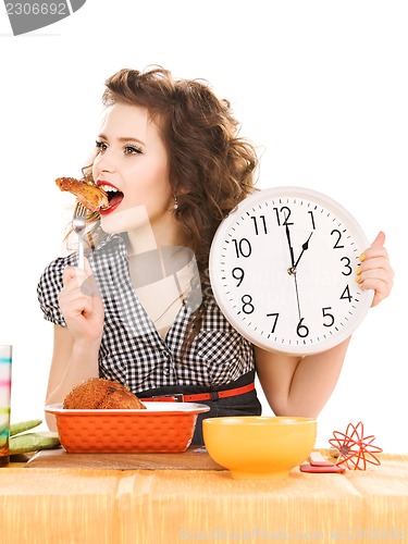 Image of young attractive woman in the kitchen