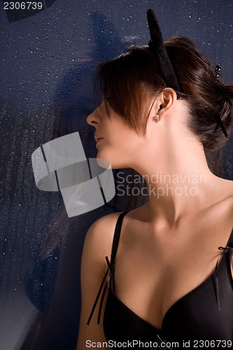 Image of woman with cat ears at the rainy window